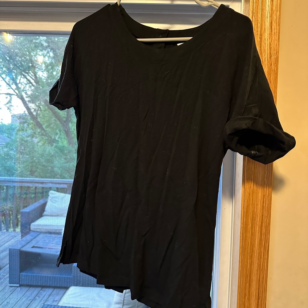 black tee with back button accents and rolled sleeves